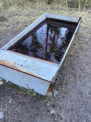 Off-site water trough using a solar panel, pump and battery to keep full.